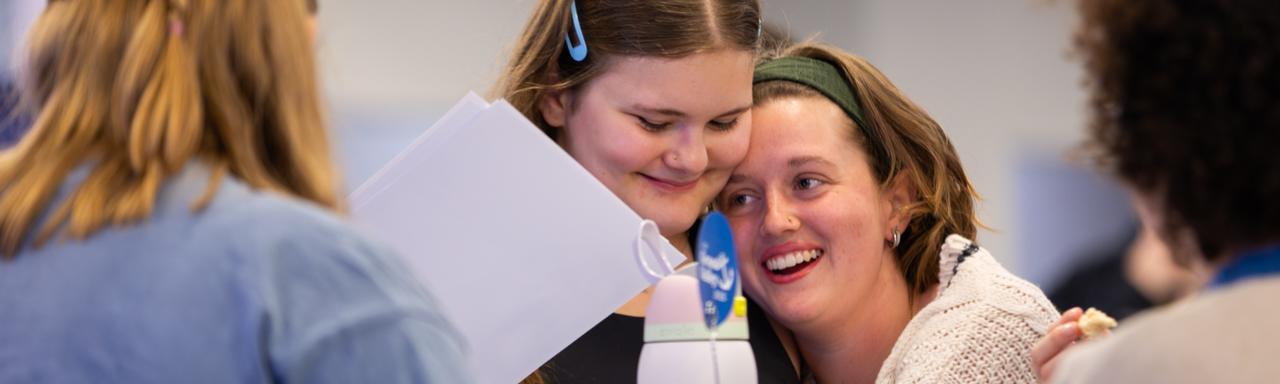 Two students hugging at I am Grand Valley